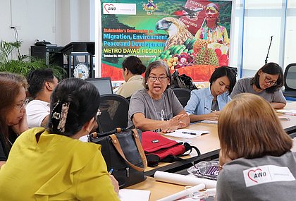 E Participants in a stakeholder dialogue discuss strategies for safe labour migration. MMCEAI brought together 52 representatives from local government agencies and community organizations (Photo: AWO International)