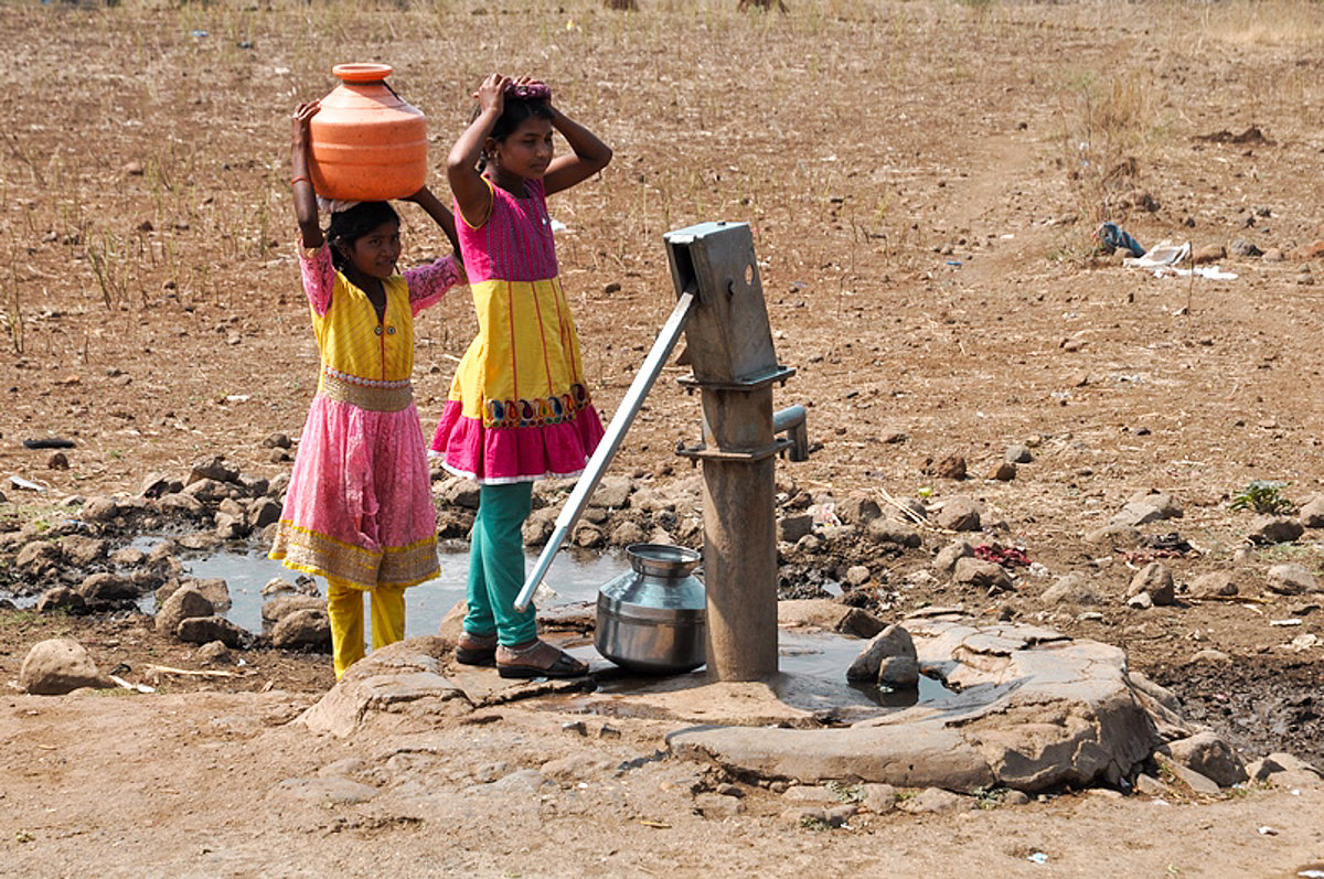 Two girls are carrying water.